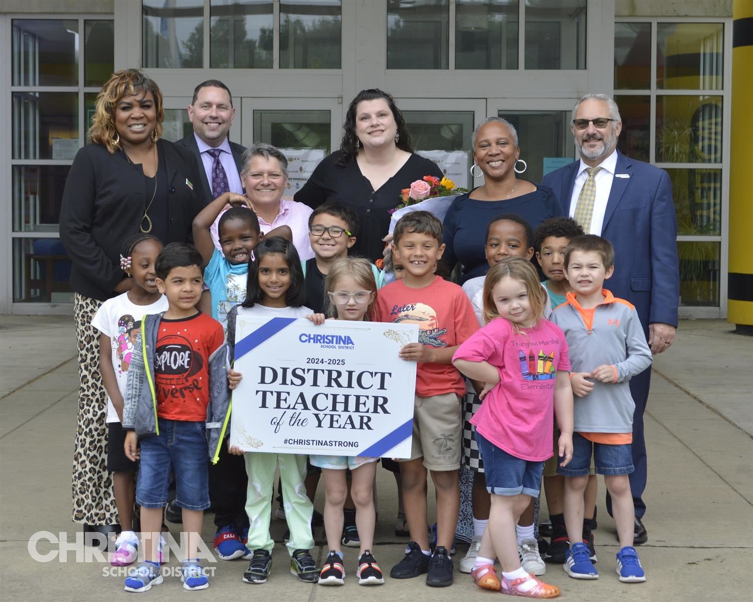 Photo of Christina School District's District Teacher of the Year 2024-2025 Stacey DiIenno with students and administration.